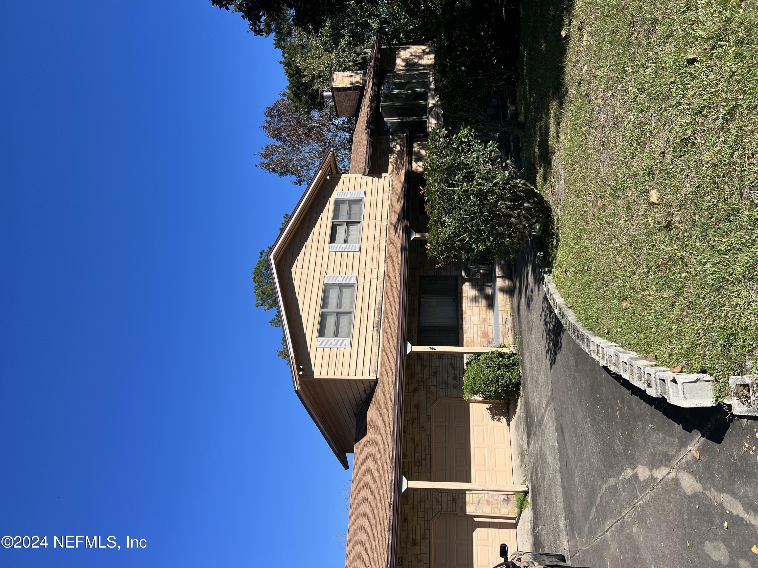 a view of house with yard