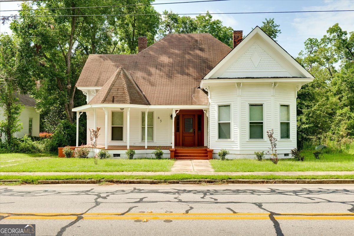 a front view of a house with garden