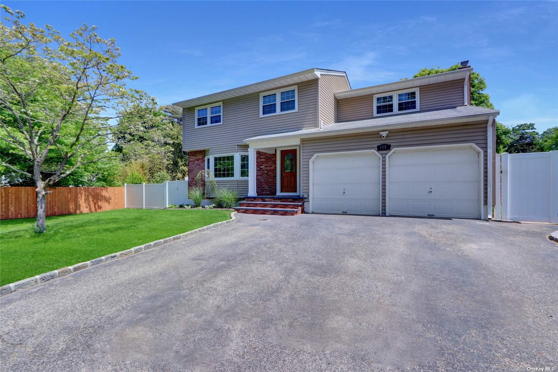 a view of a house with a yard and garage