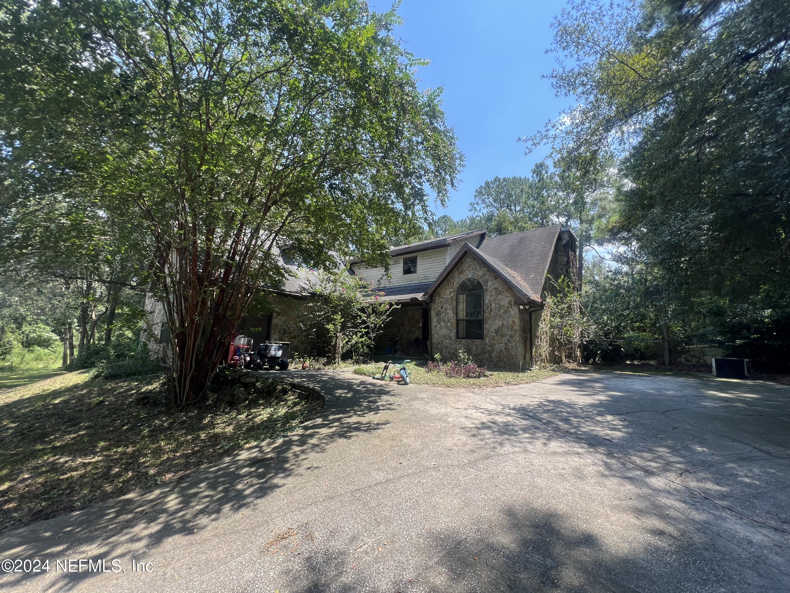 a view of a house with a tree in the background