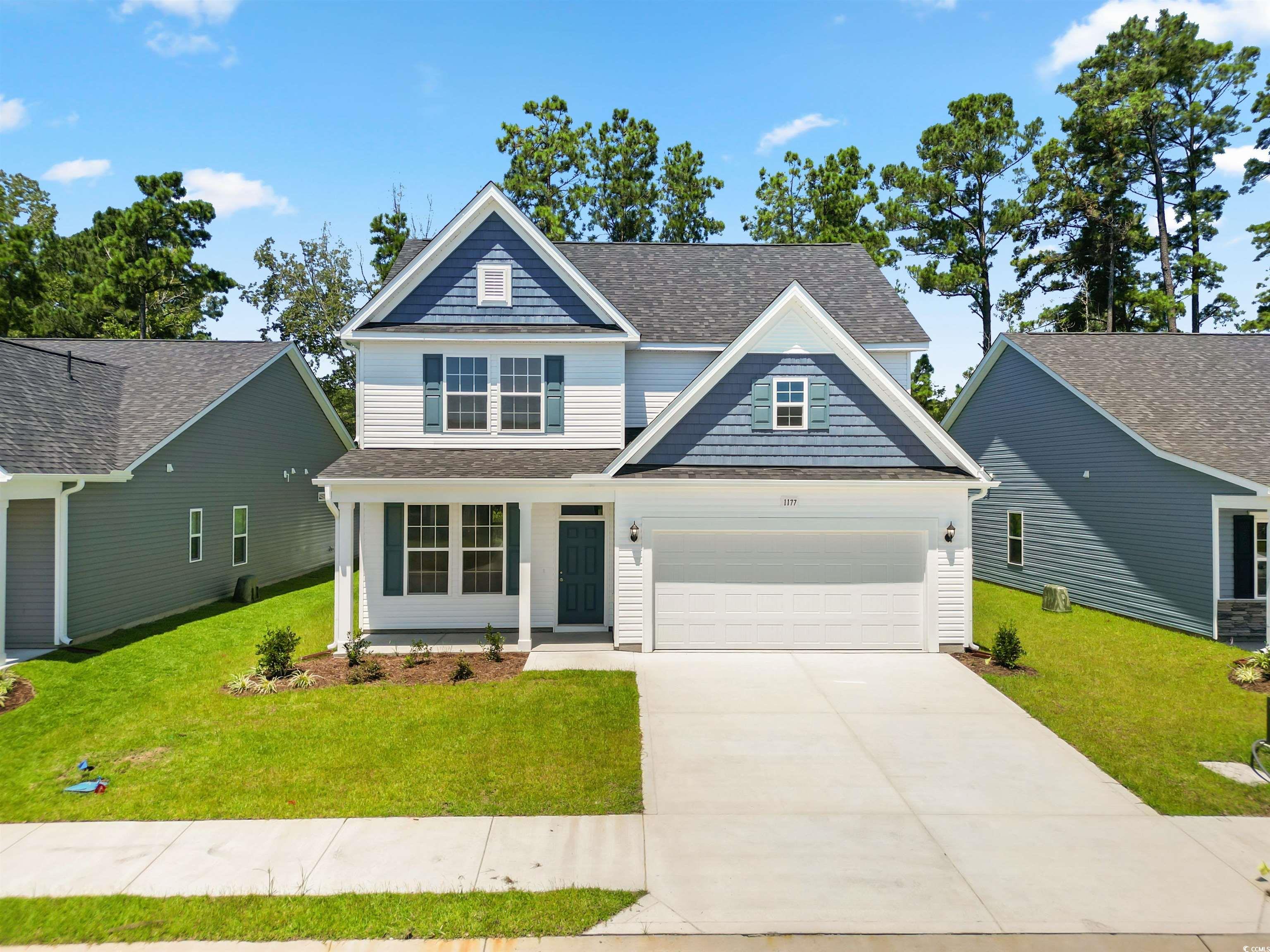 Craftsman-style house with a garage and a front ya