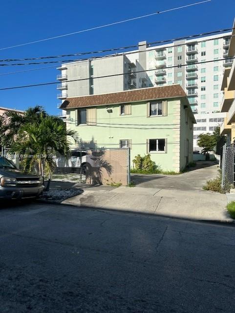 a front view of a building with parking