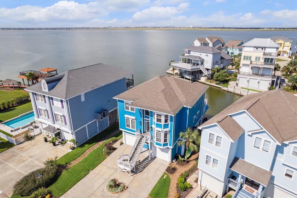 a aerial view of a house with swimming pool and furniture