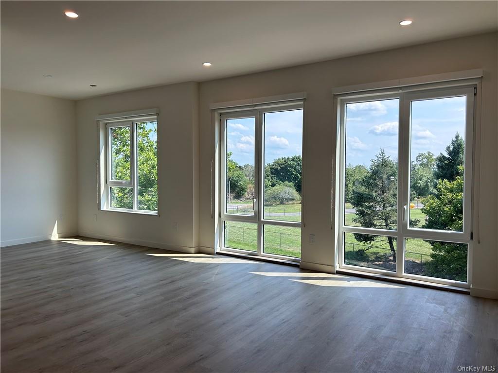 a view of a room with wooden floor and balcony