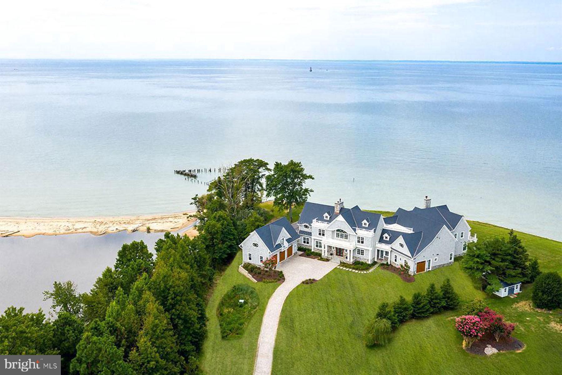 an aerial view of a house with outdoor space swimming pool and ocean view