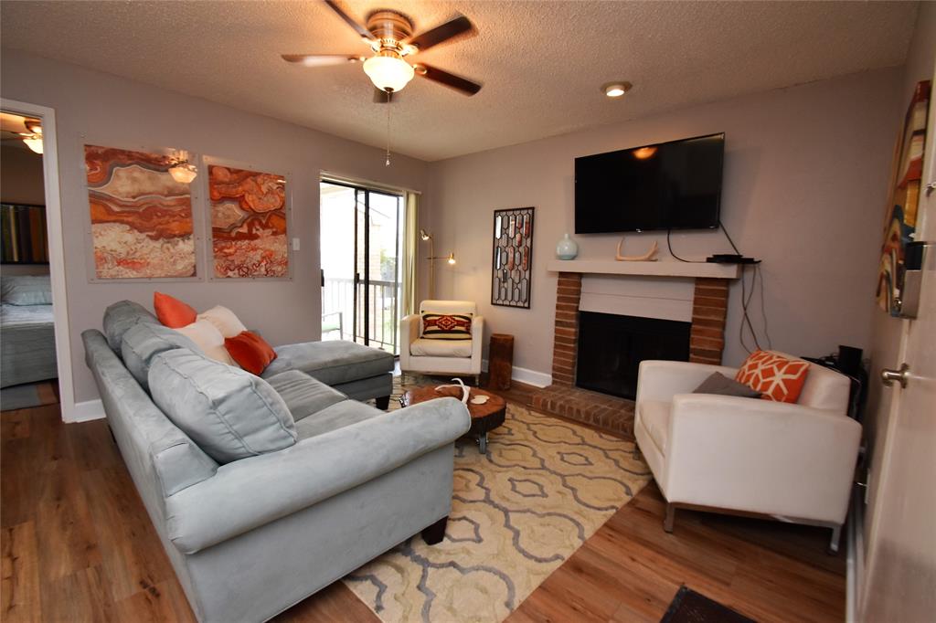 a living room with fireplace furniture and a flat screen tv