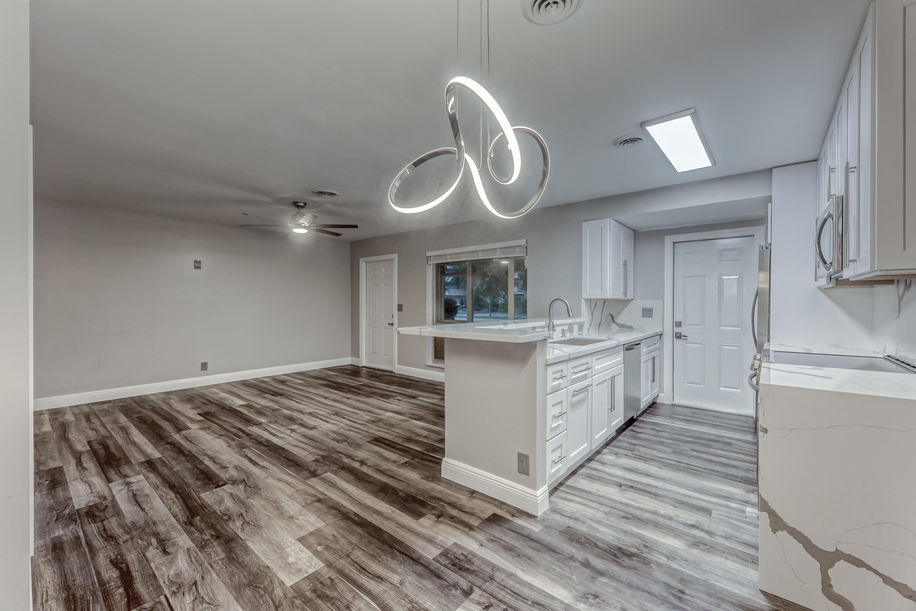 a large kitchen with kitchen island a sink stainless steel appliances and cabinets