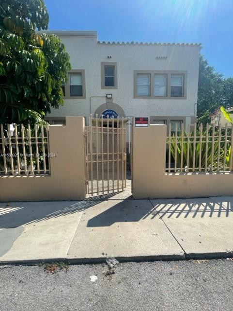 a view of a house with a wooden fence