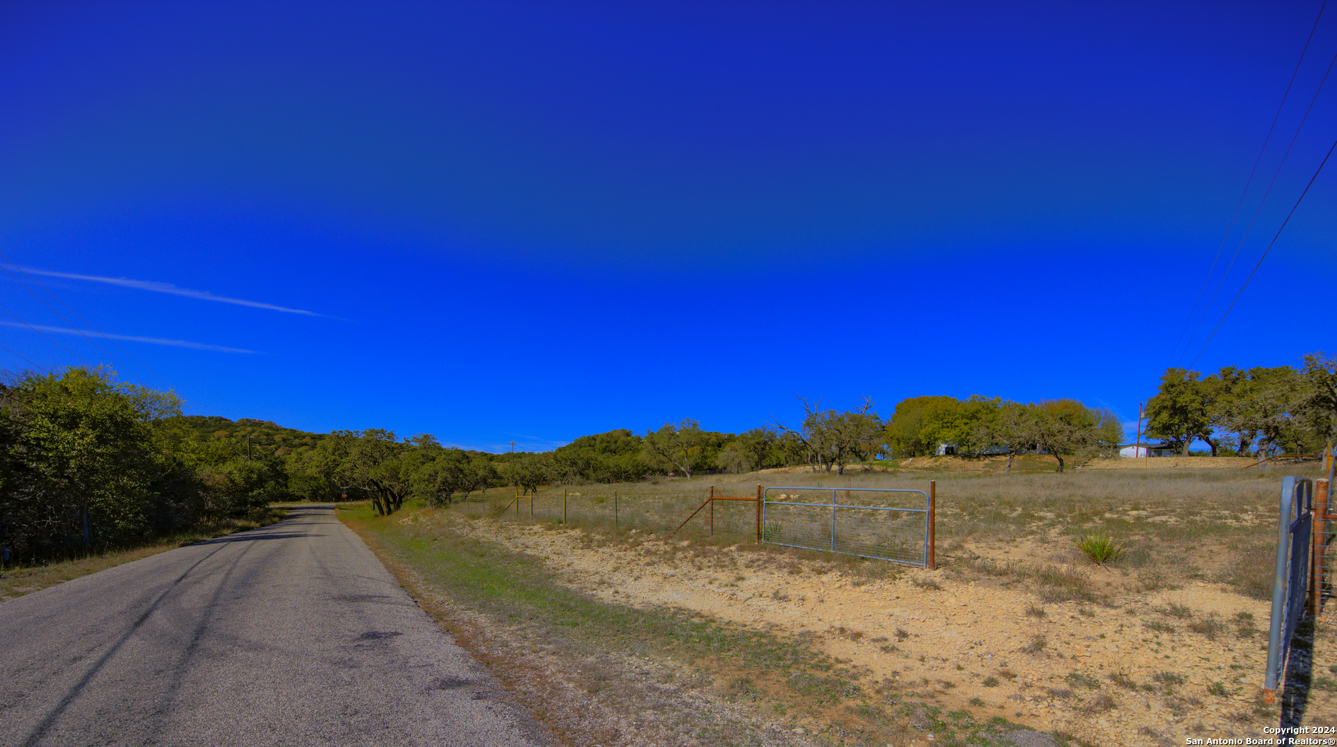 a view of dirt road with a building in the background