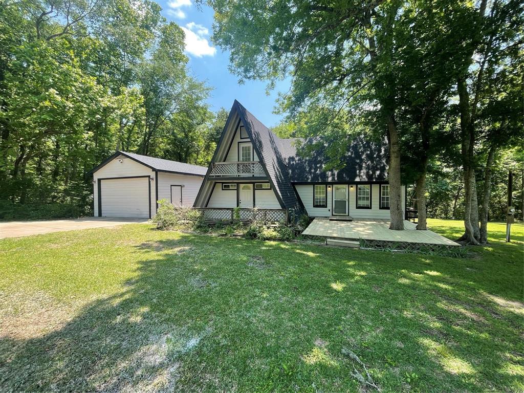 a view of a house with a backyard and a slide