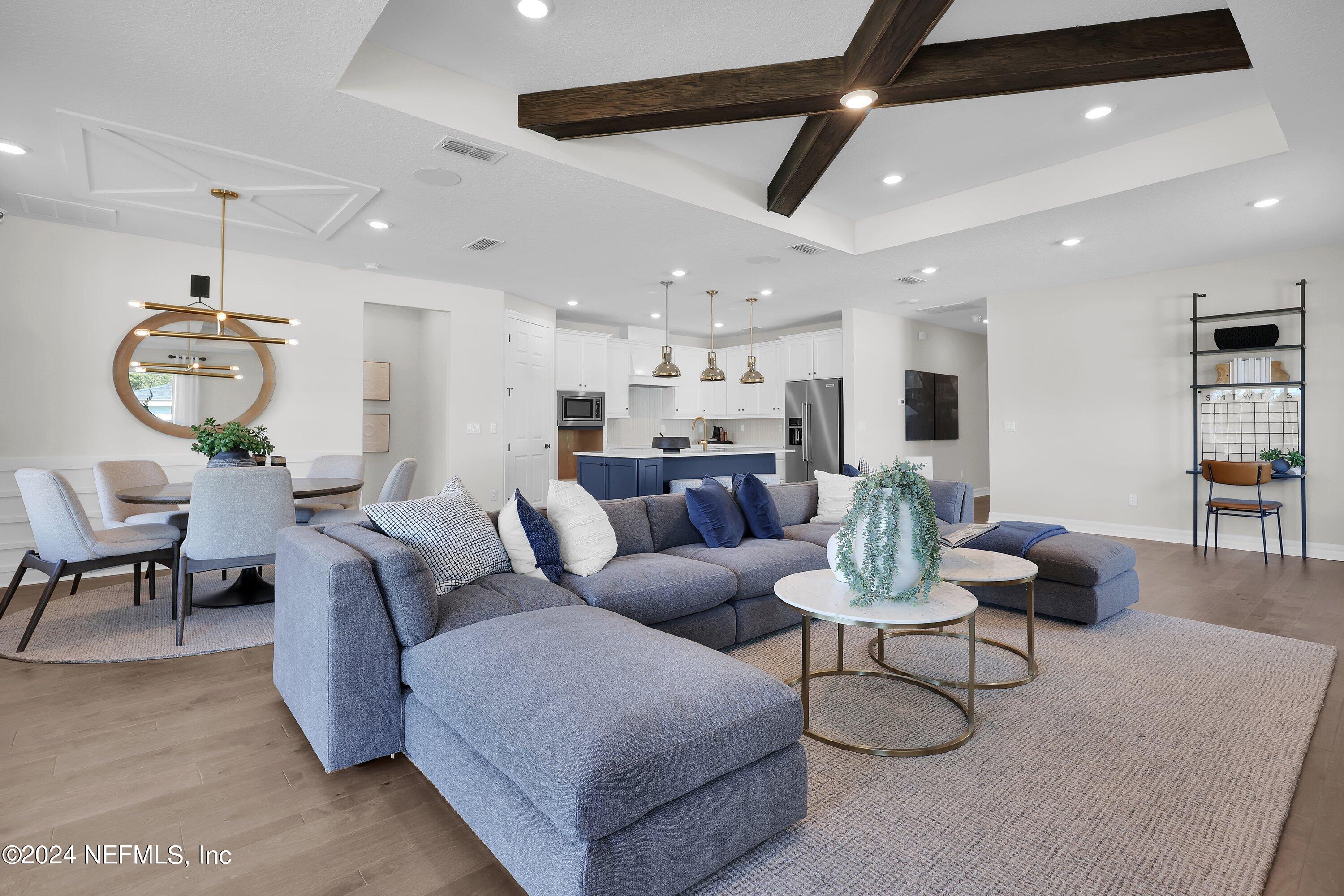 a living room with furniture and kitchen view