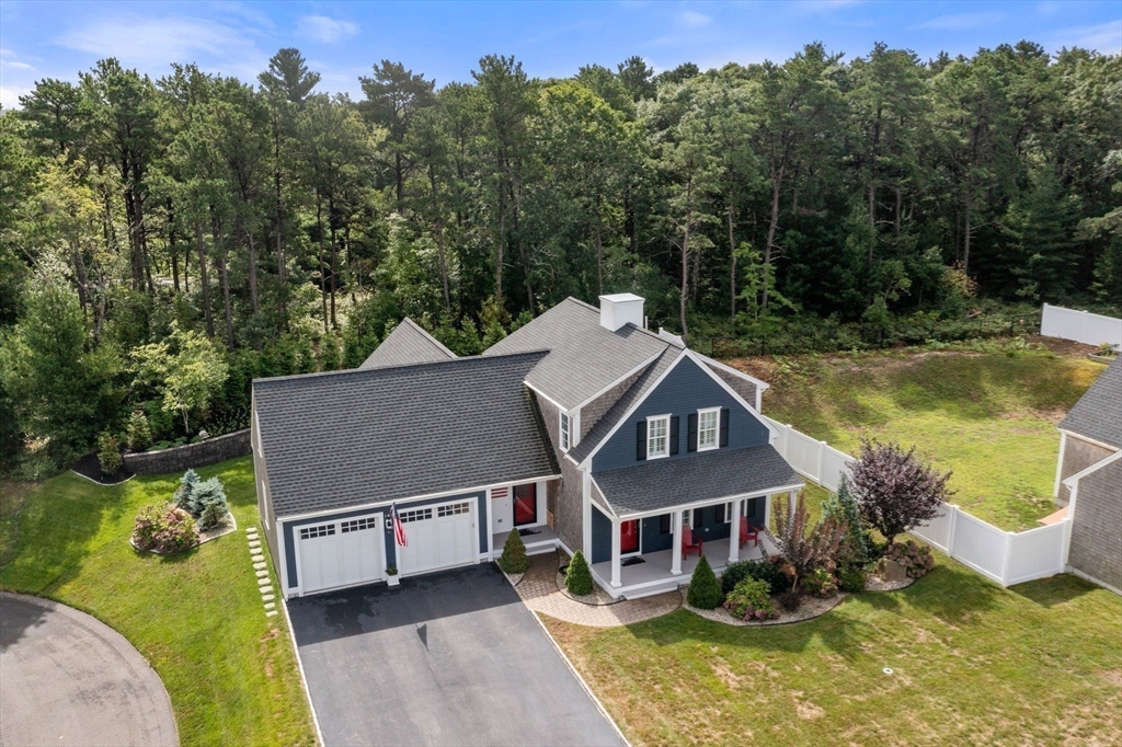 an aerial view of a house with swimming pool and a yard