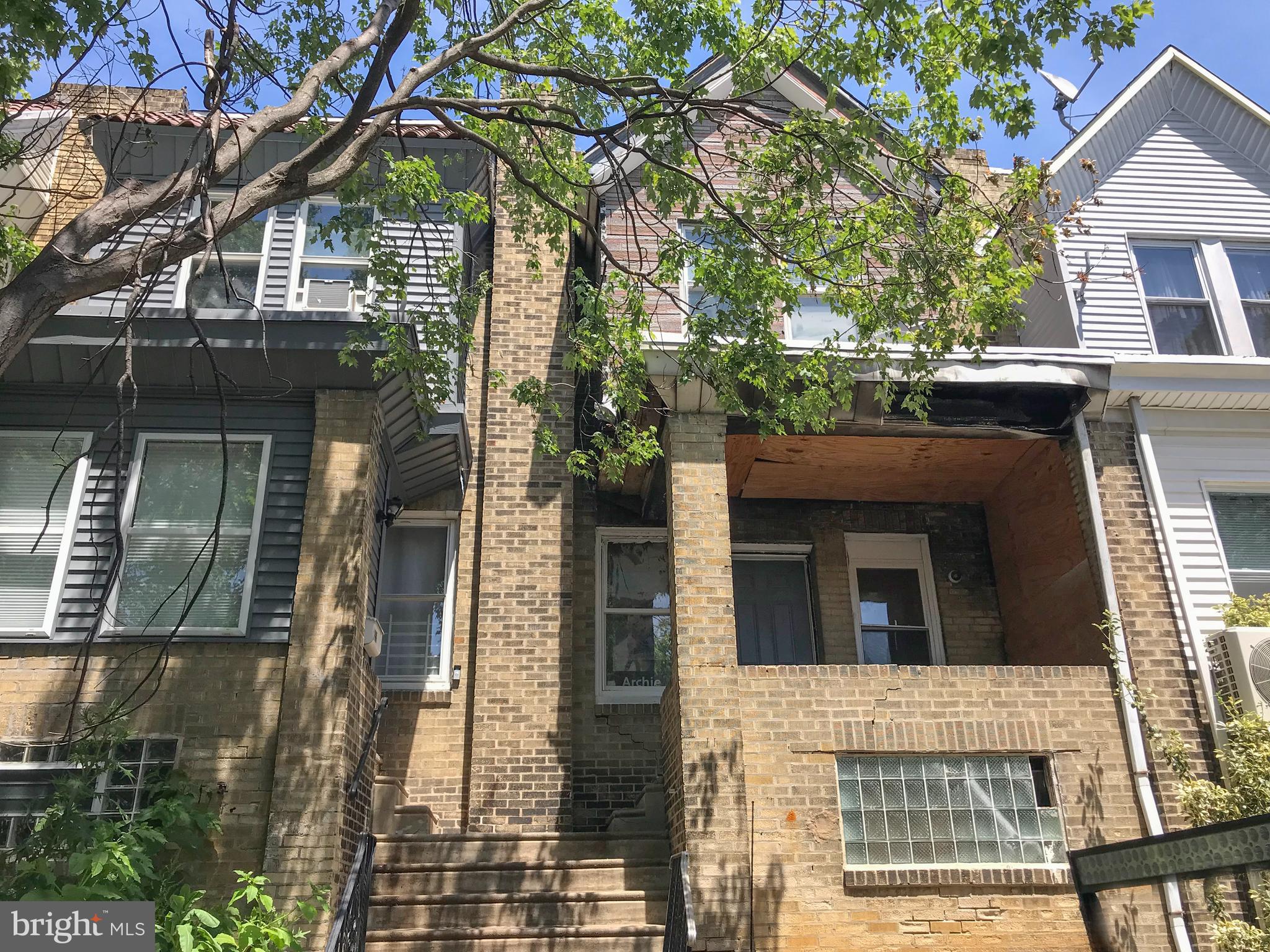 a view of a house with a tree