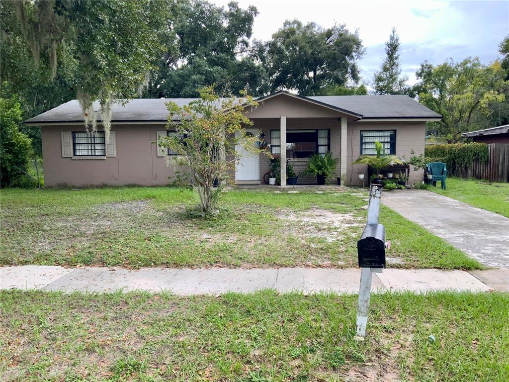 a front view of a house with a yard and porch