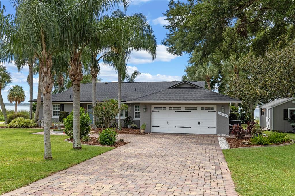 a front view of a house with a yard and a garage