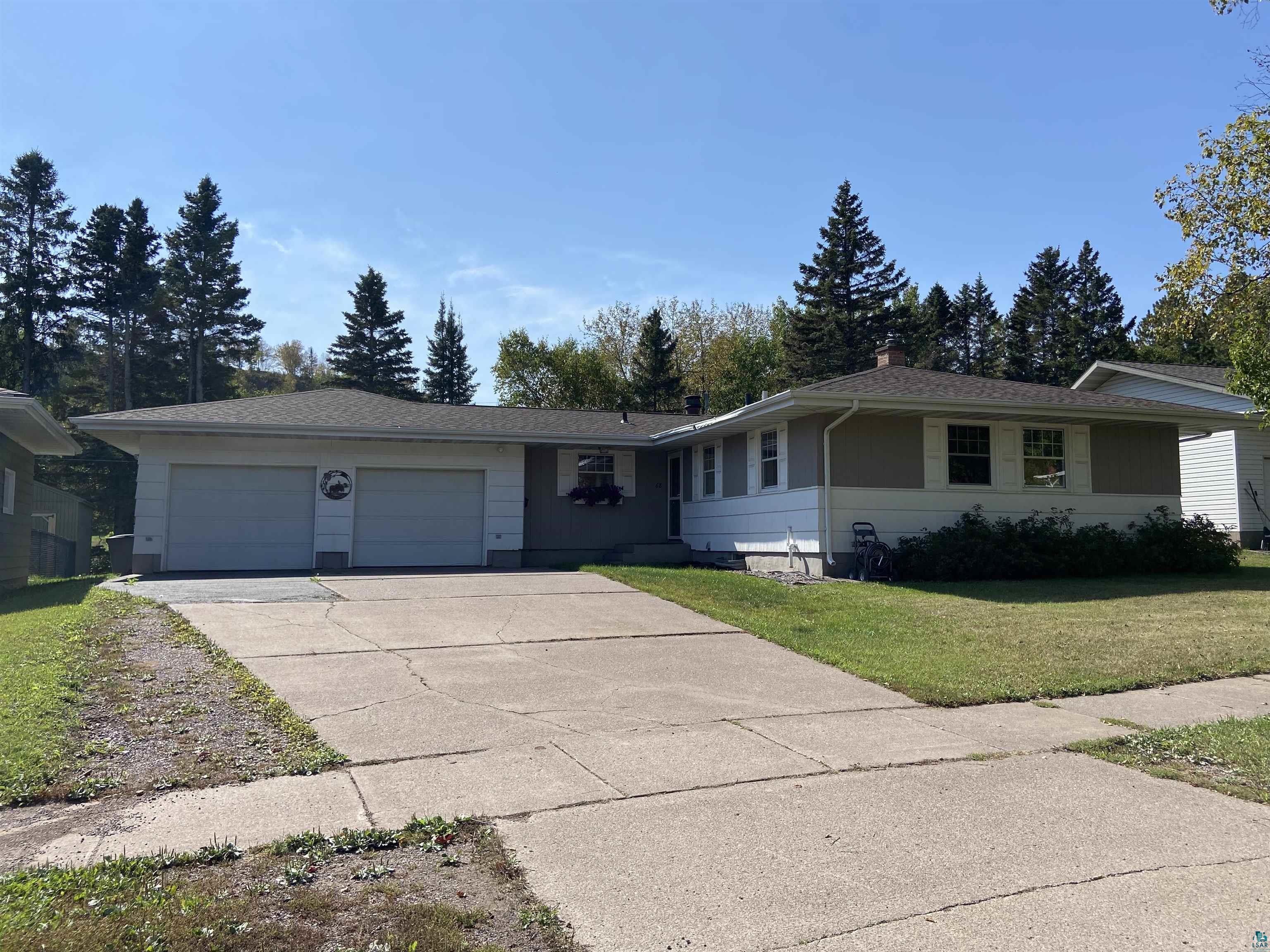 Ranch-style home with a front yard and a garage