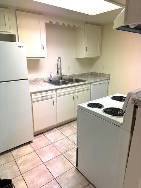 a kitchen with appliances a sink and a refrigerator