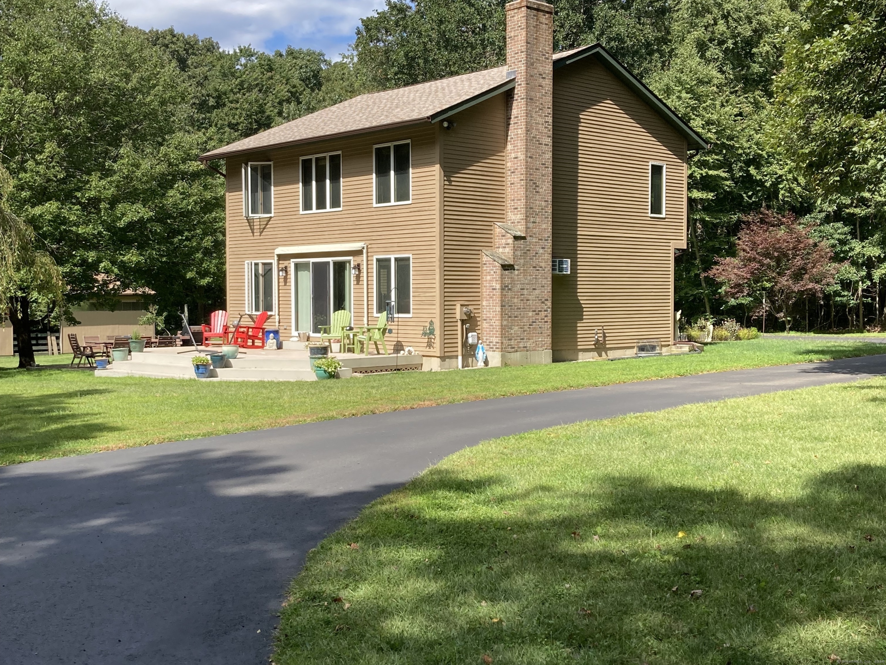 a front view of house with yard and green space