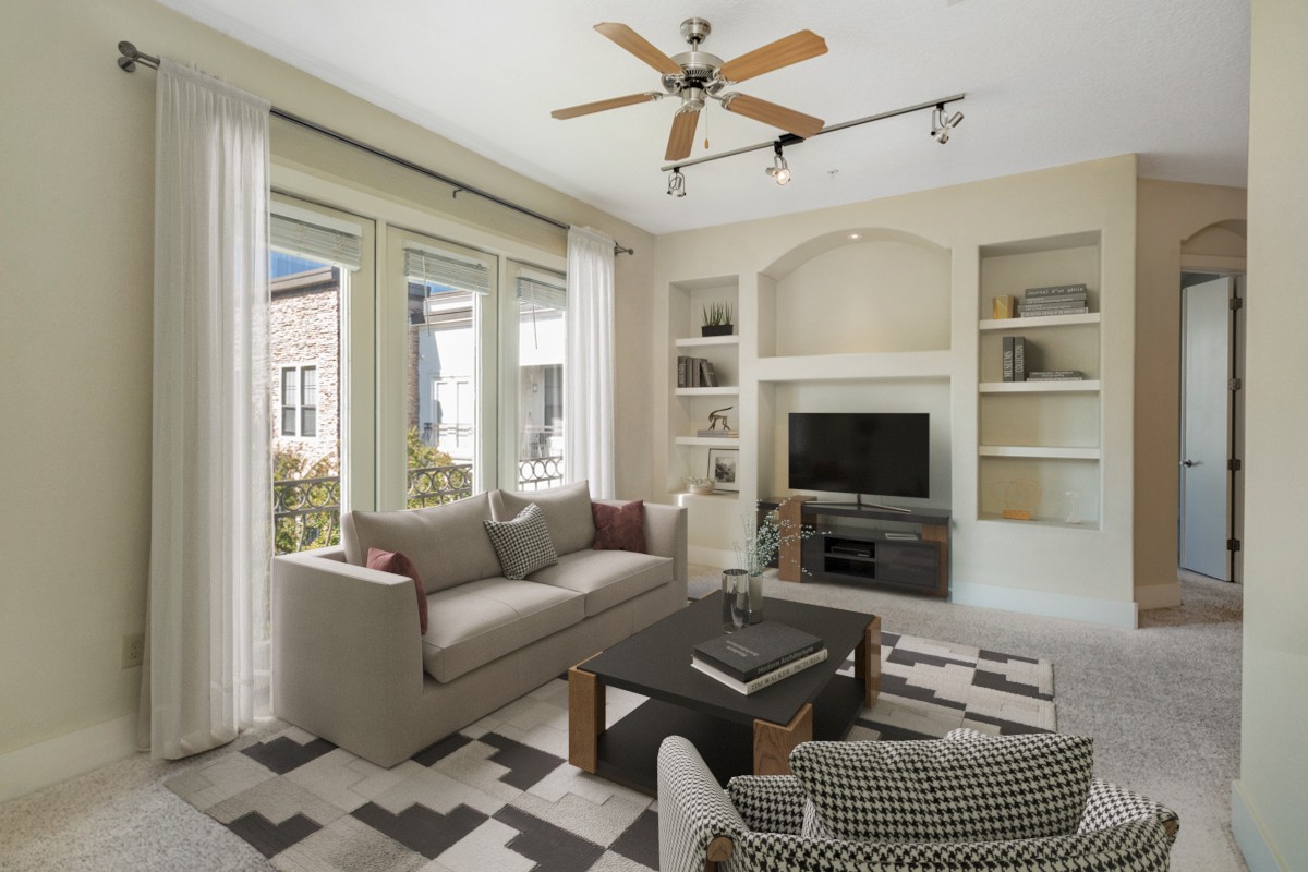 a living room with furniture a flat screen tv and a large window