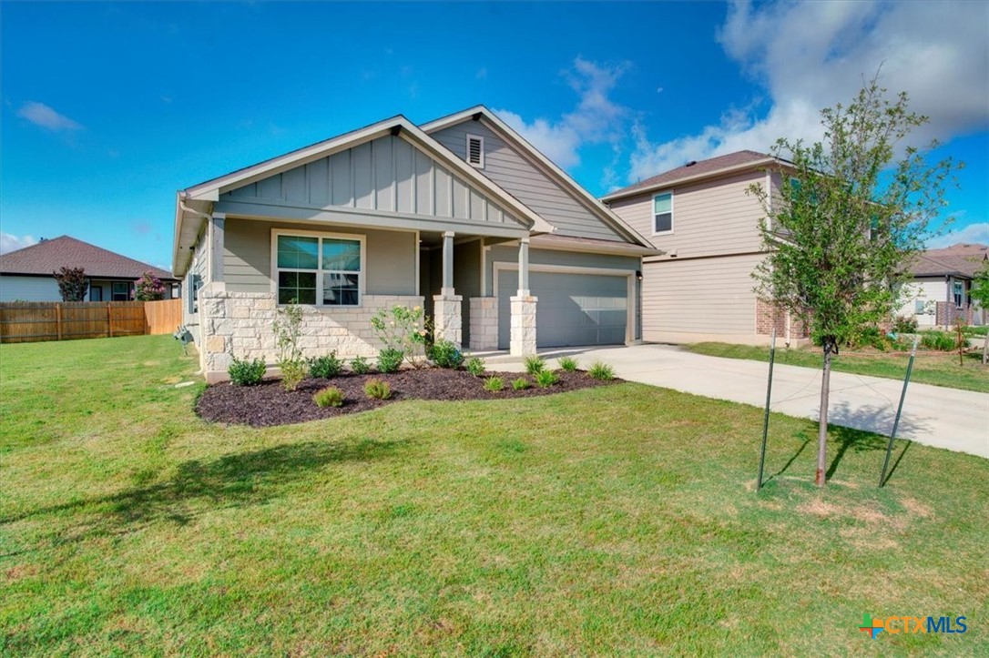 a front view of a house with yard and green space