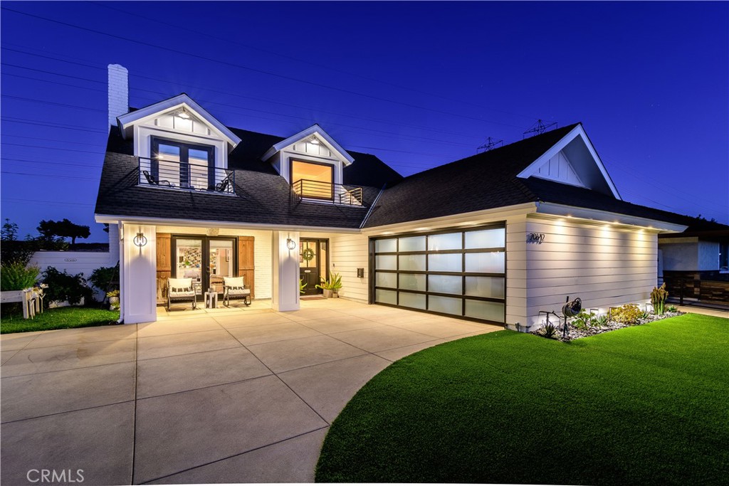 a front view of a house with a yard and outdoor seating