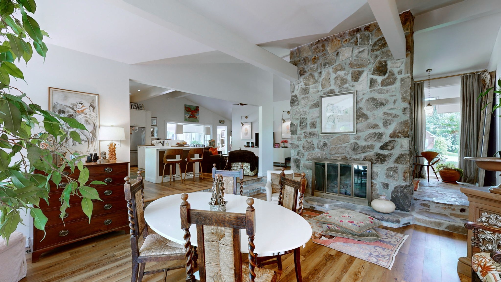 a dining room with furniture a fireplace and wooden floor