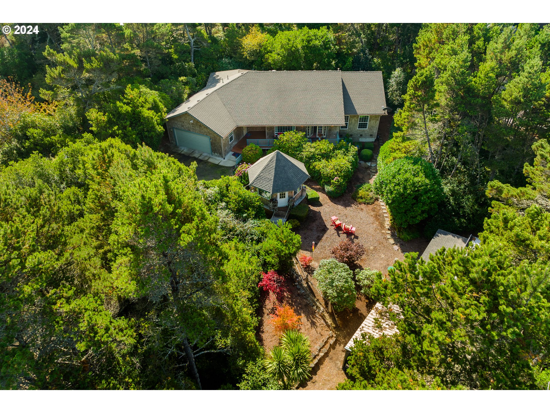 a aerial view of a house with yard and outdoor seating