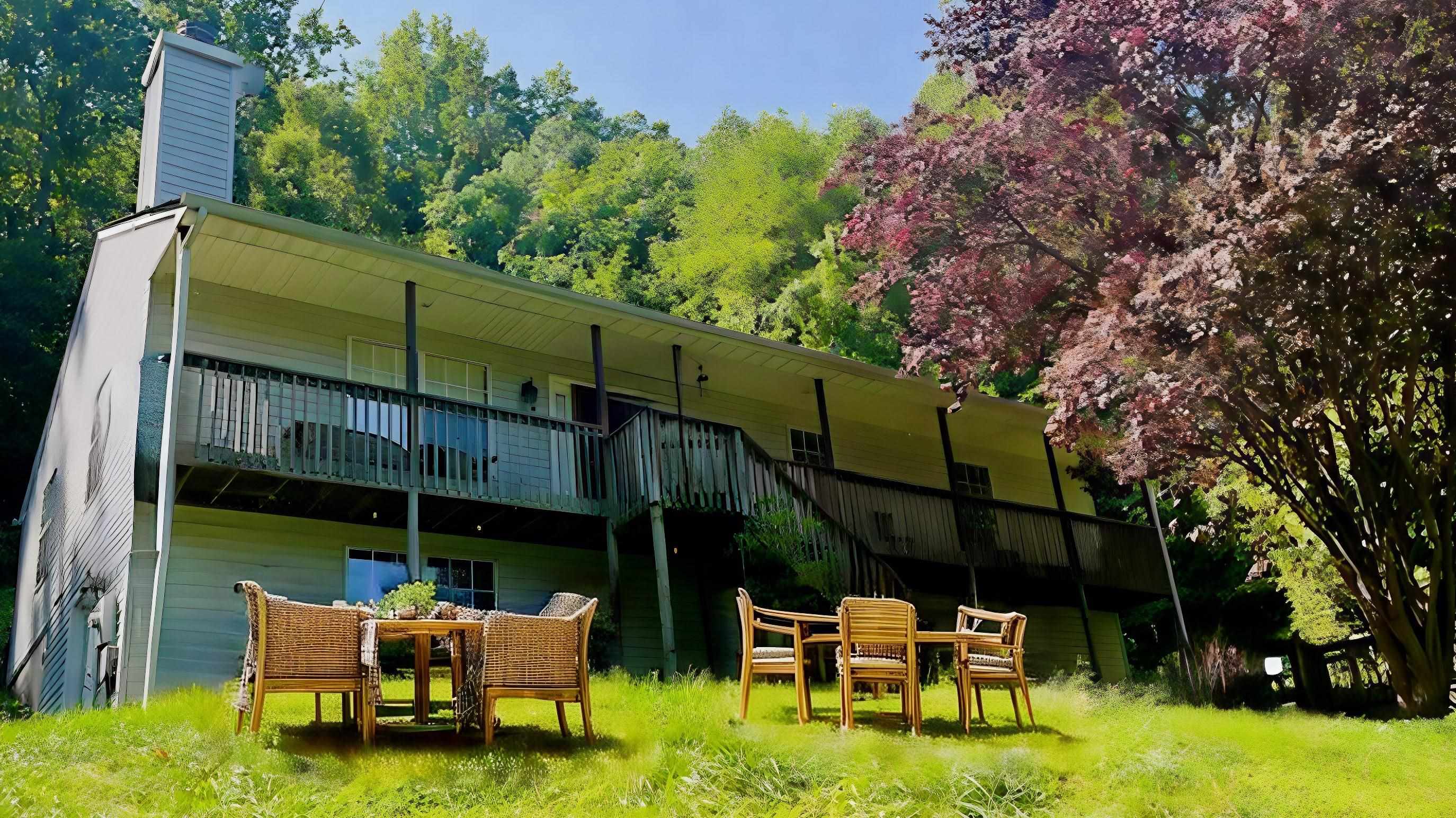 a backyard of a house with table and chairs