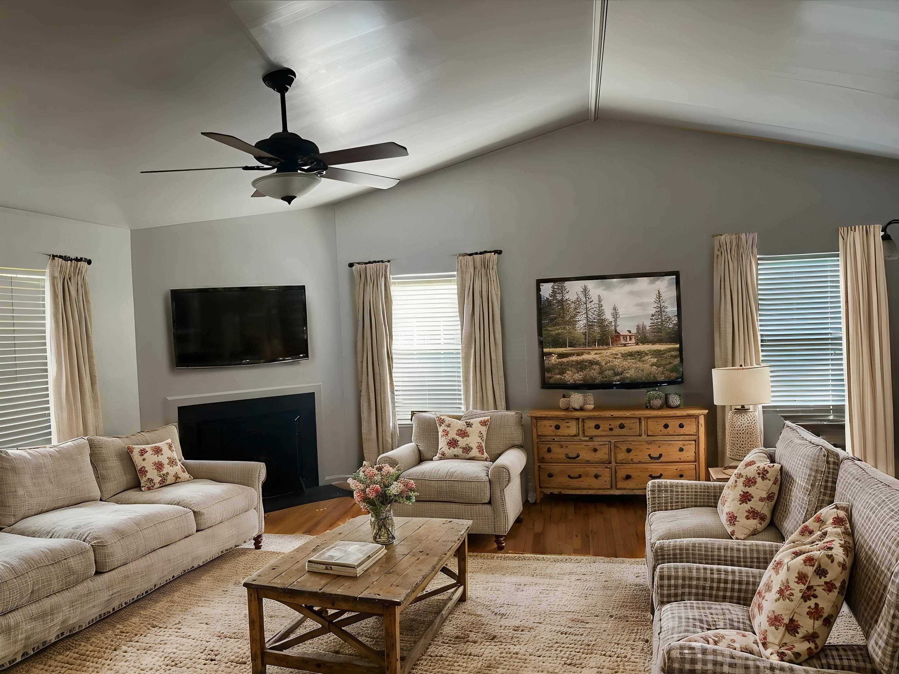 a living room with furniture a flat screen tv and a fireplace