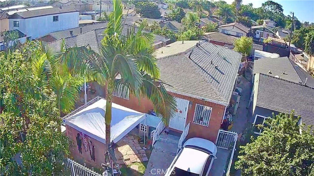 an aerial view of a house with a yard and potted plants