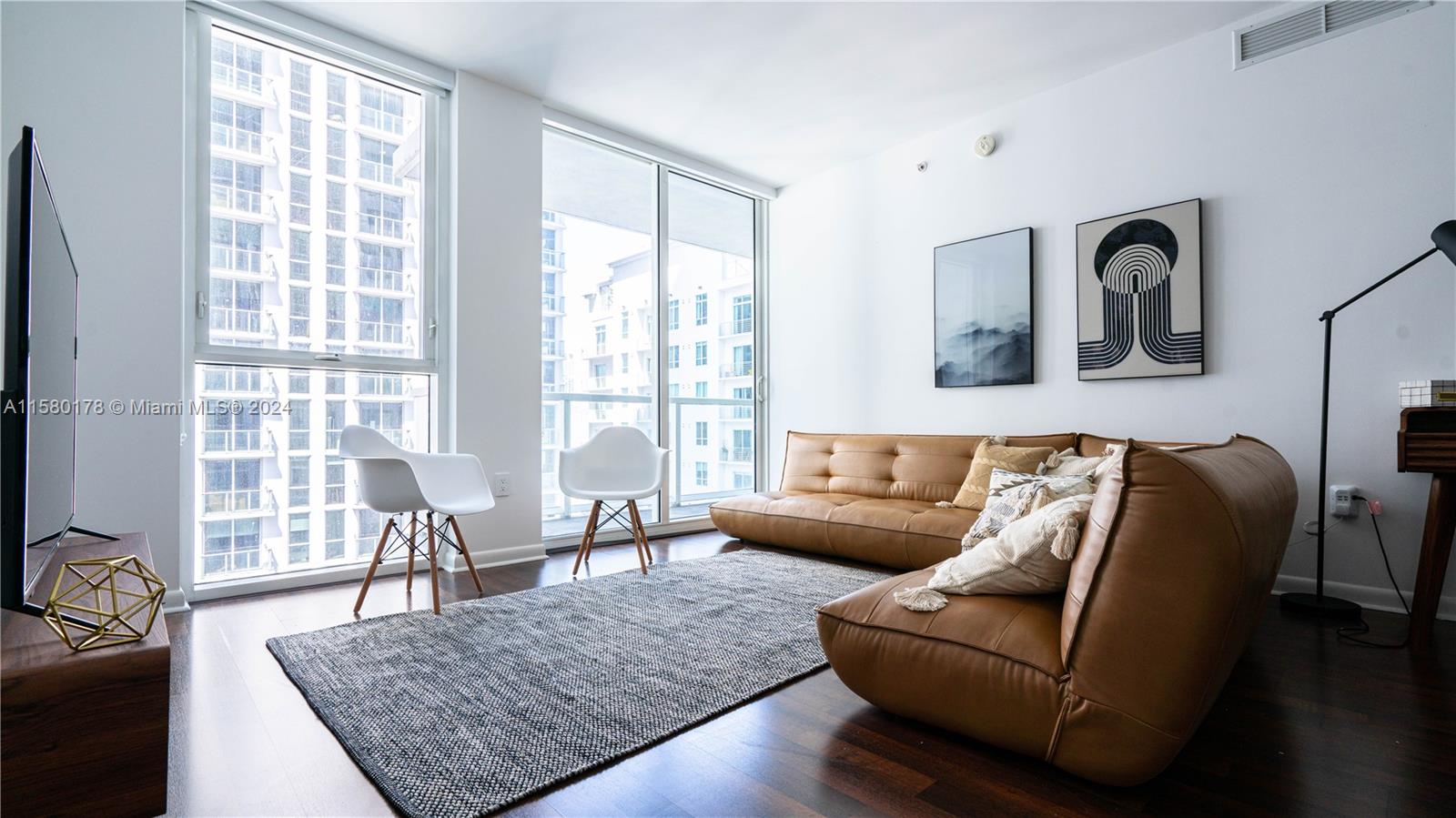 a living room with furniture rug and window