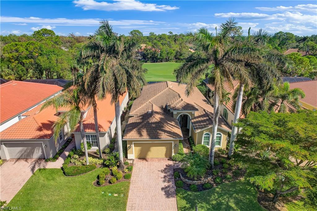 an aerial view of a house with a yard and lake view