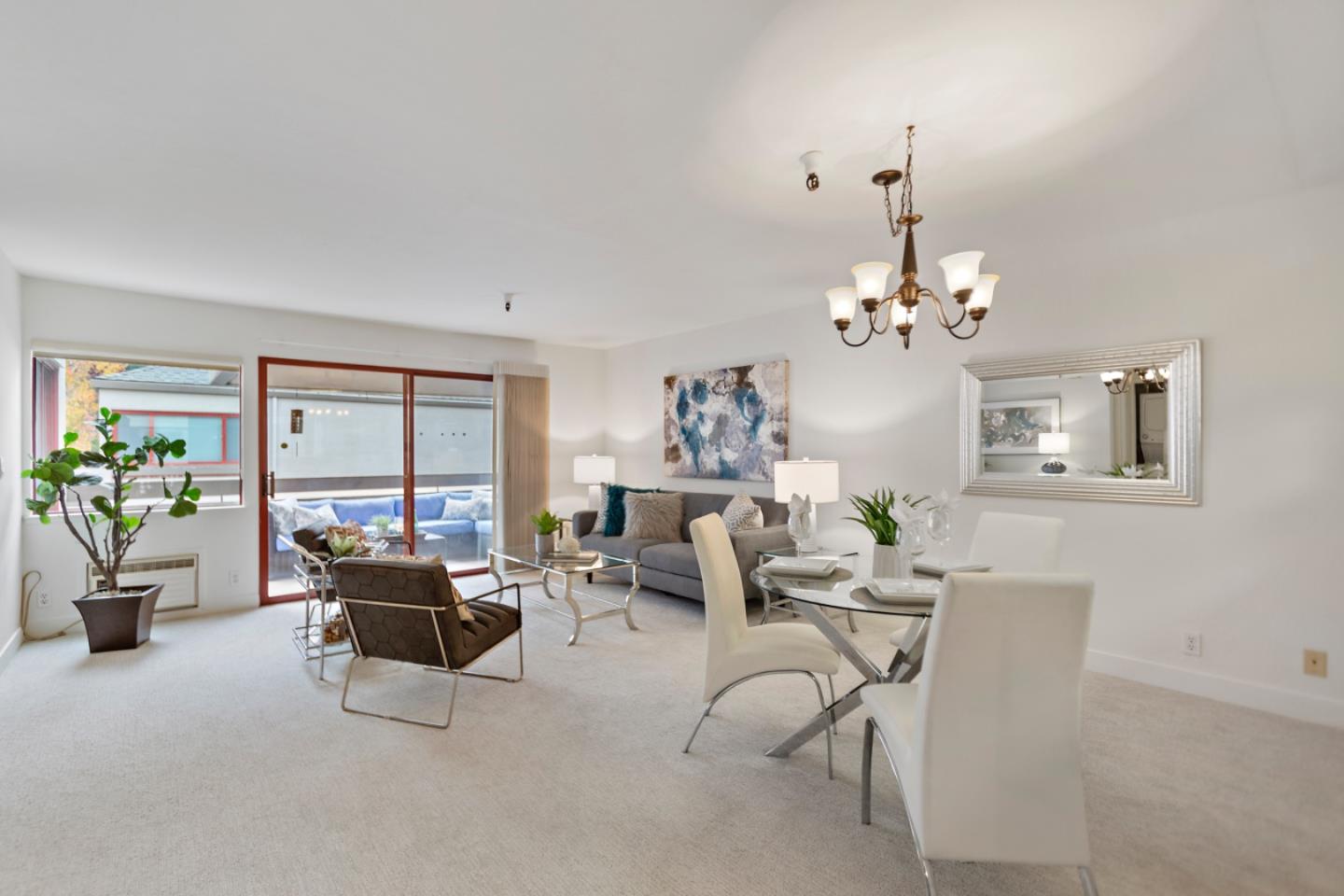 a living room with furniture and a chandelier