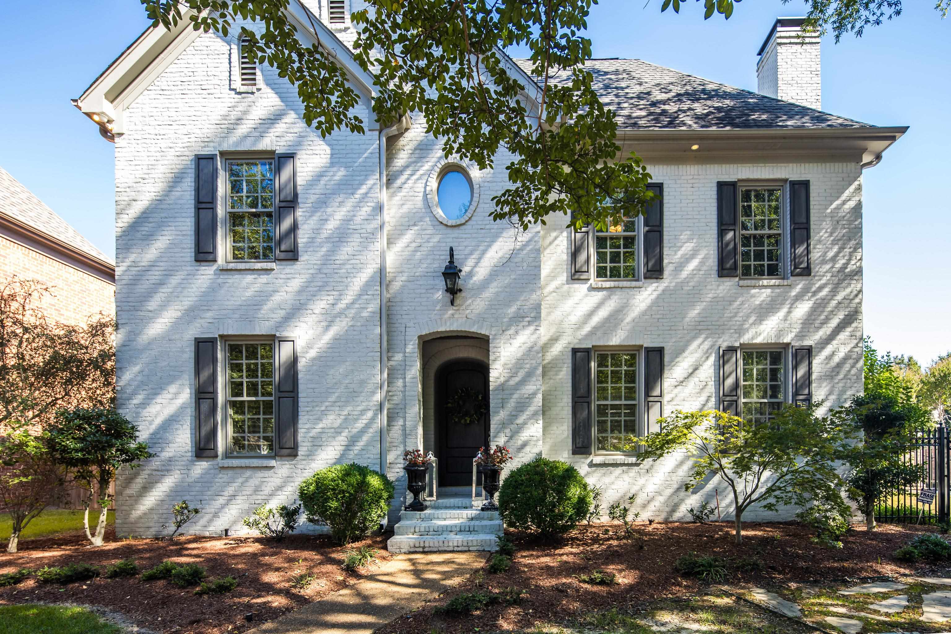 a front view of a house with garden