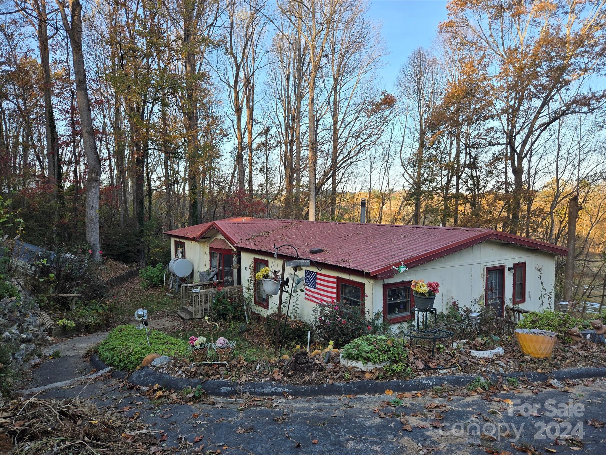 a view of a house with a yard and sitting area