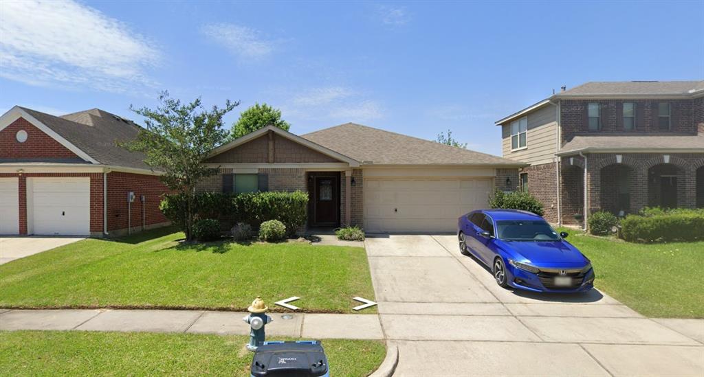 a front view of a house with a garden and yard