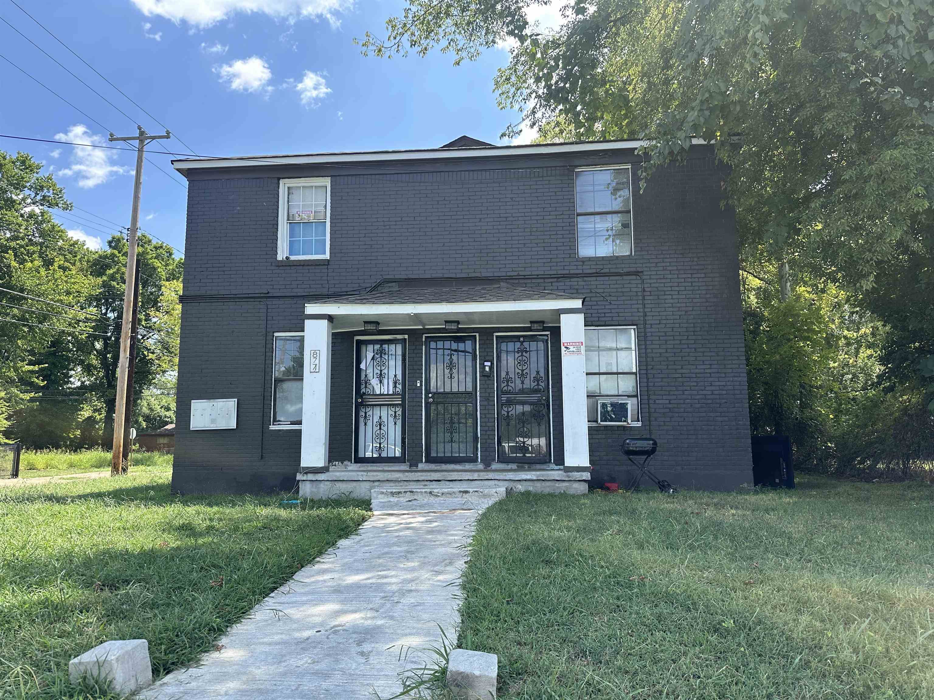 front view of a house with a yard