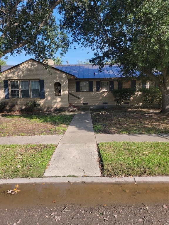 a front view of a house with a yard and a garage