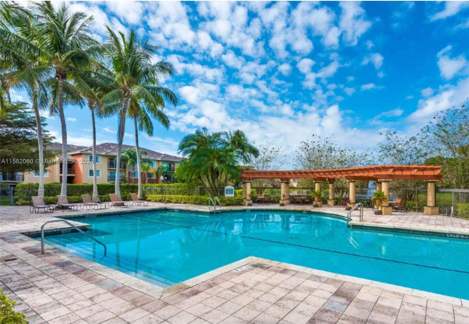 a view of a swimming pool with an outdoor seating