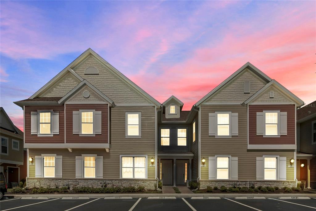 a front view of a residential apartment building with a yard