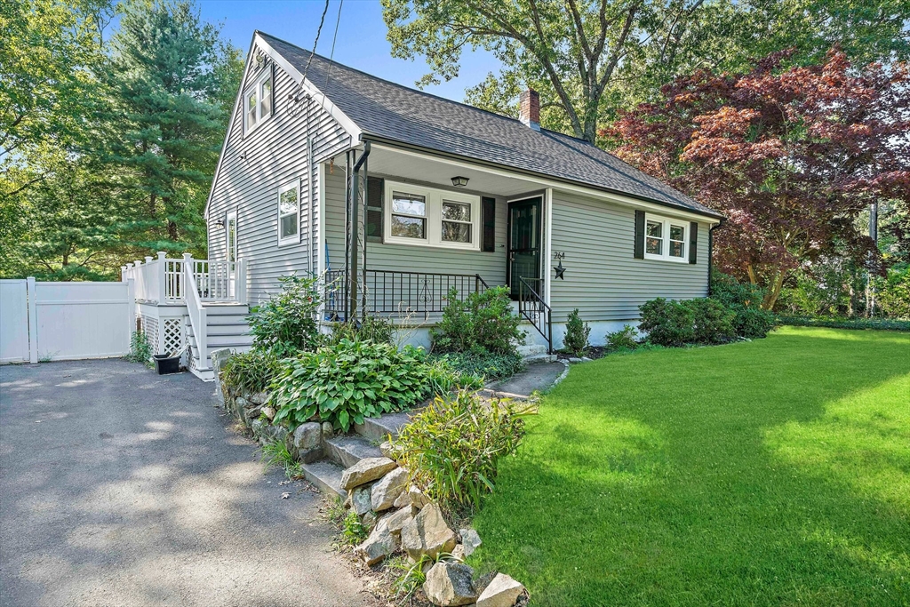 a view of a house with yard and a garden