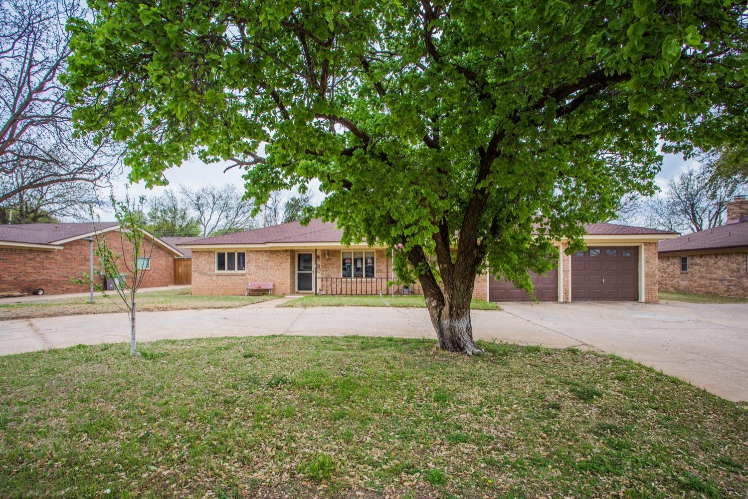 a house with tree in front of it