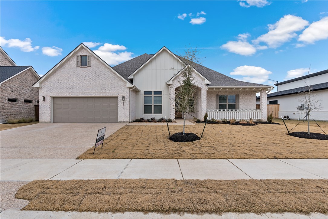 View of front facade featuring a garage and covere