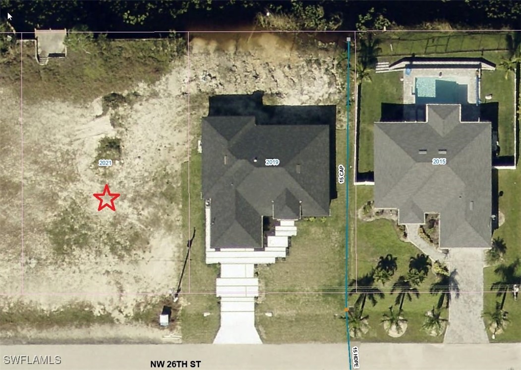 an aerial view of a house with a yard