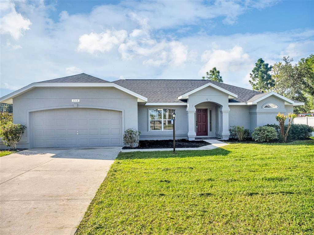 a front view of a house with yard