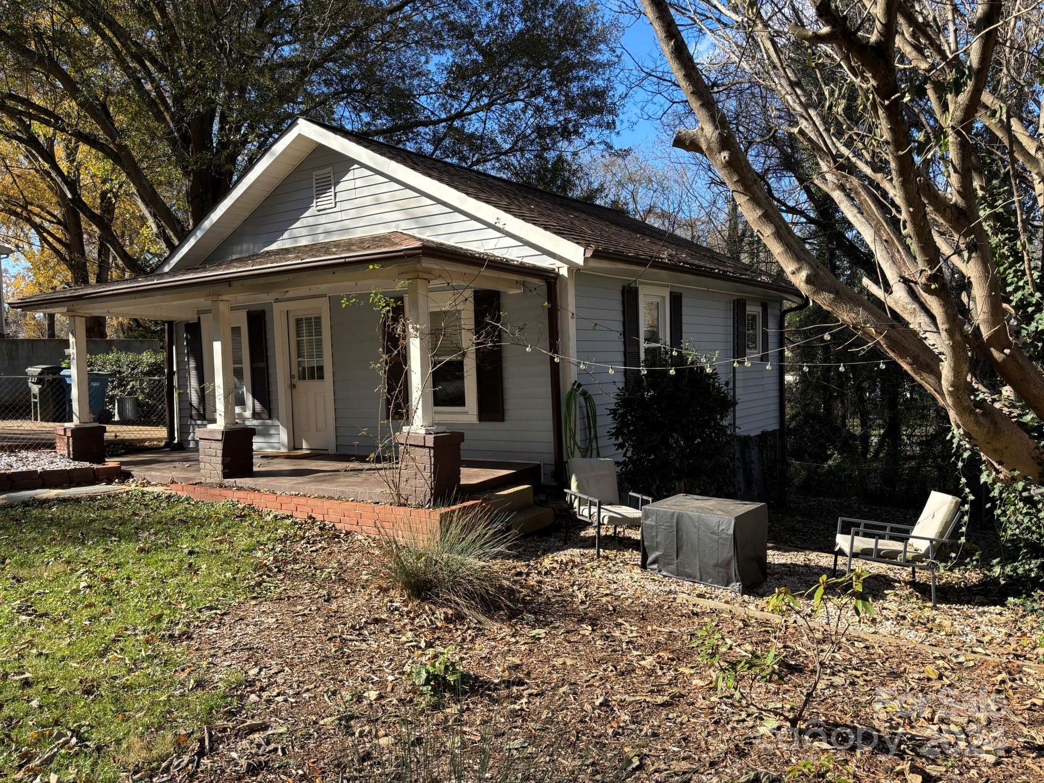 a view of a house with backyard sitting area and porch