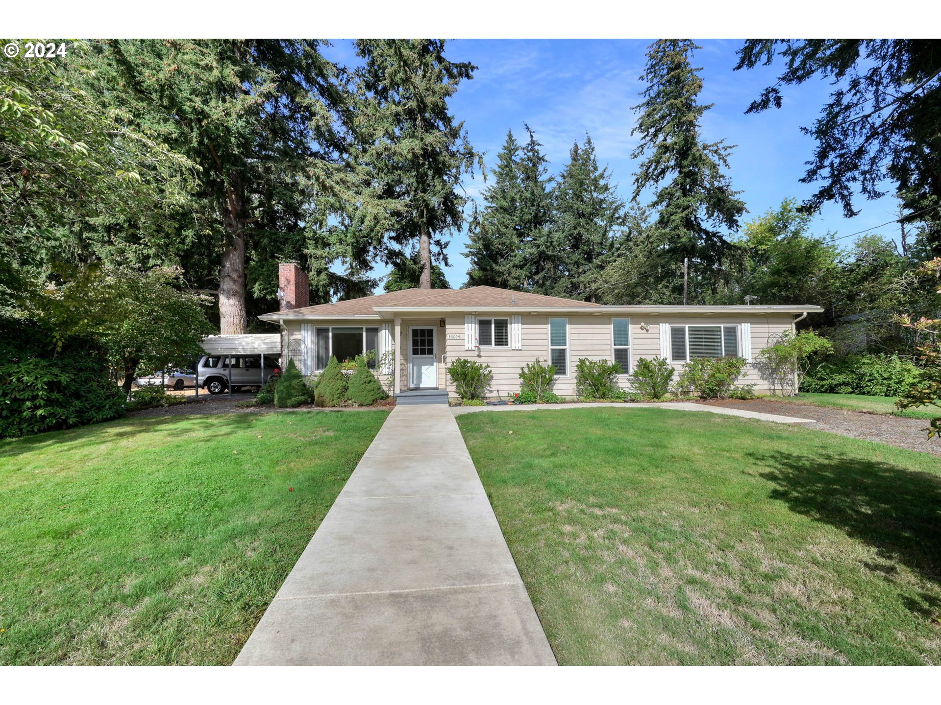 a front view of a house with yard porch and garden