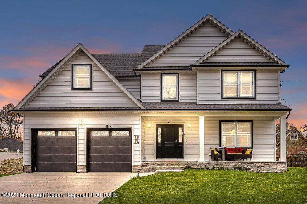 a front view of a house with a yard and garage