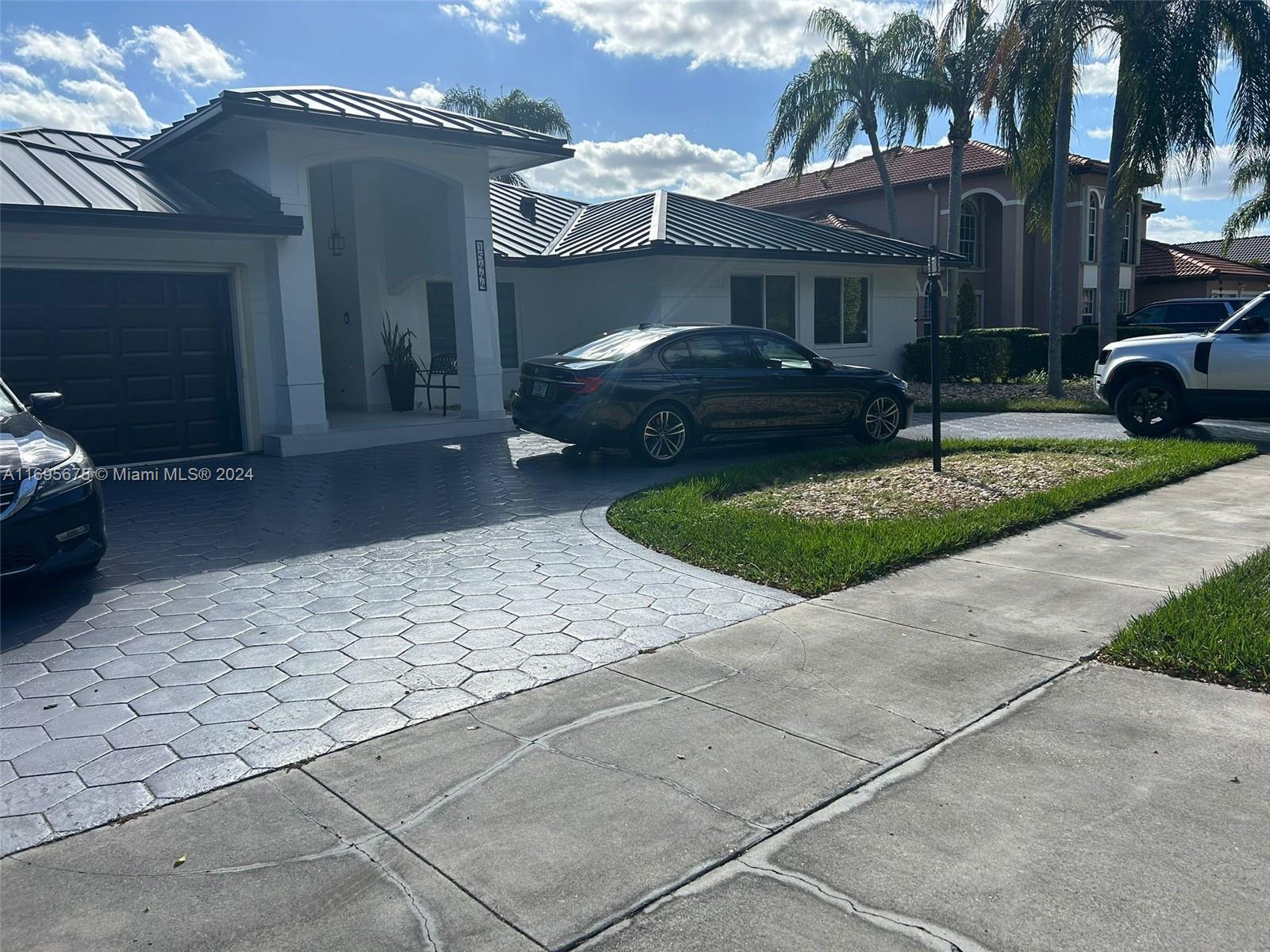 a couple of cars parked in front of a house