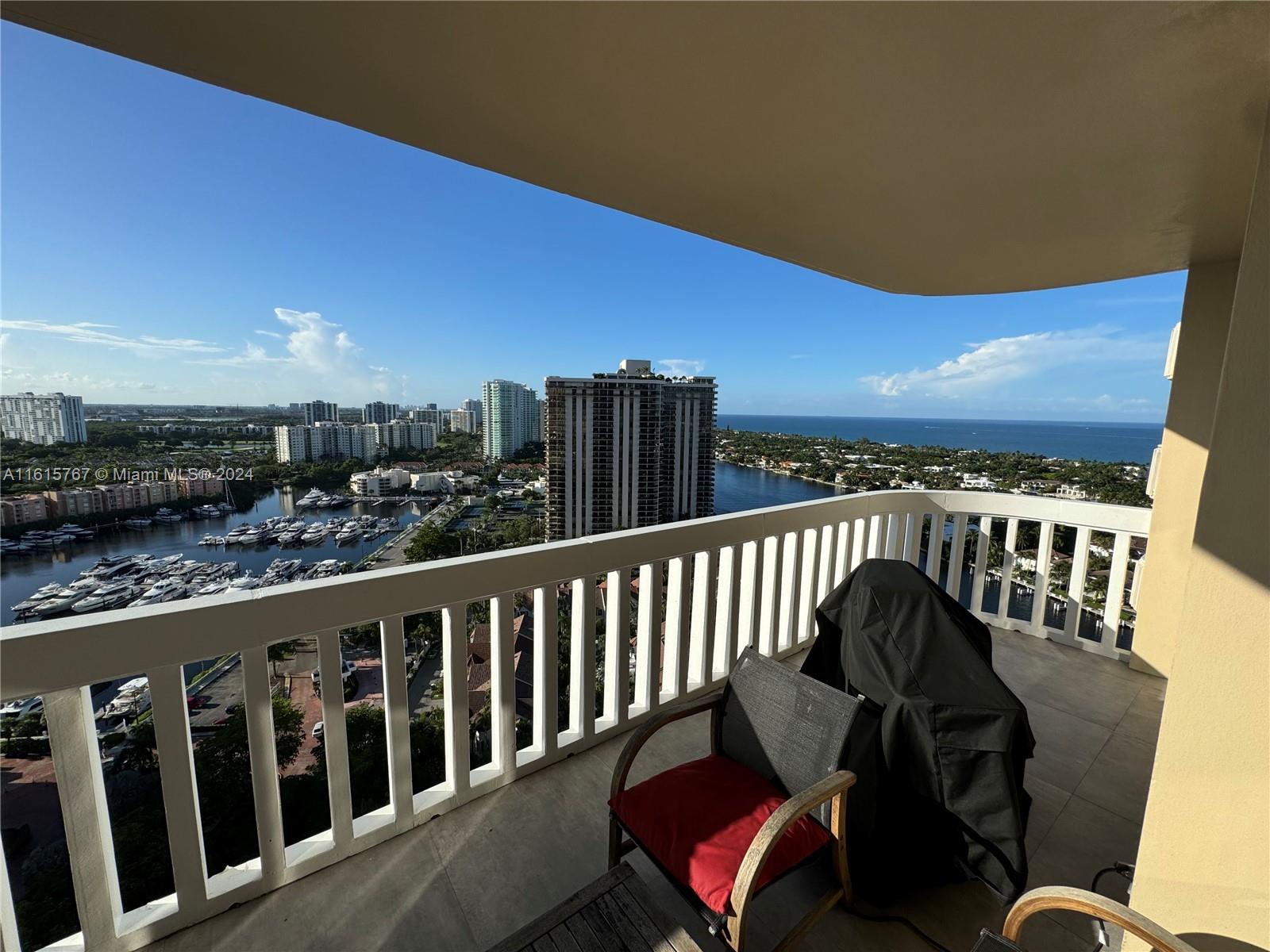 a view of a balcony with chair and wooden floor